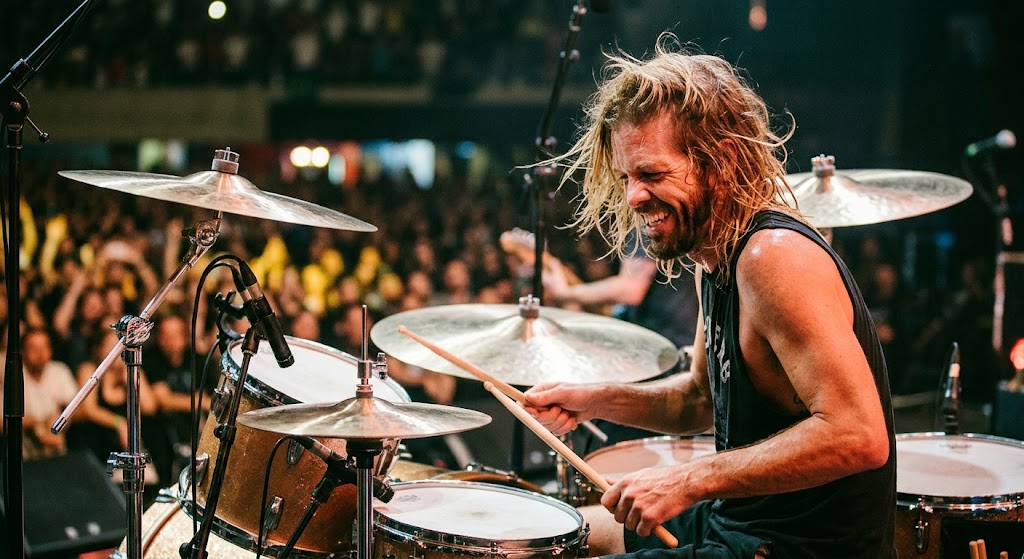 Taylor Hawkins performing with Foo Fighters while exploring the facts surrounding his cause of death.